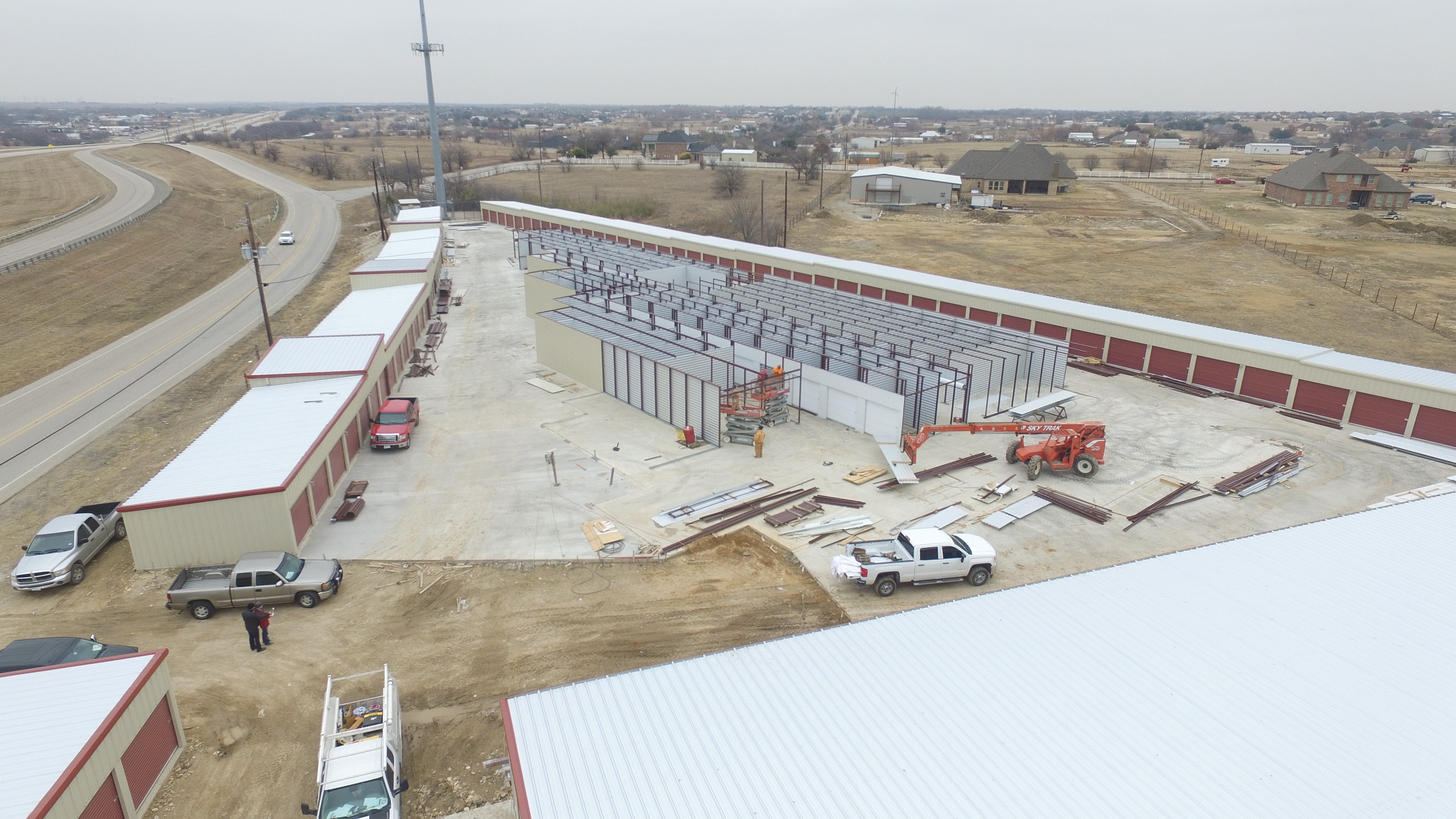 Steel building construction workers erecting metal frame